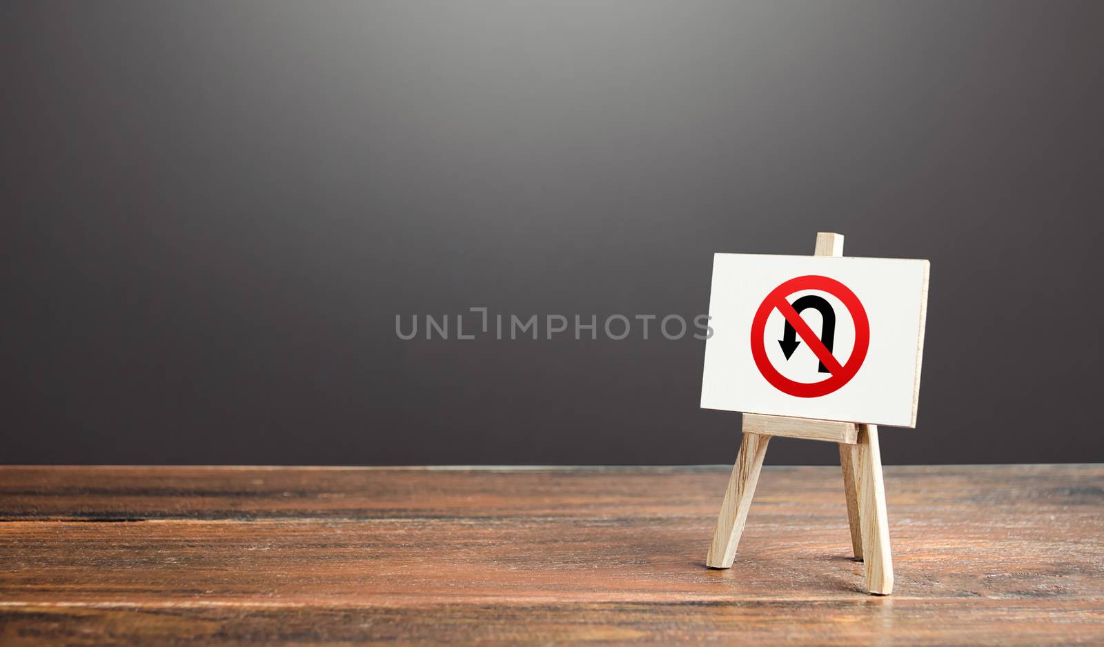 Easel with no turning back traffic sign. Go to the goal, don't stop. Assertiveness and striving, moving forward without retreating. Finish things. There is no way back. Obstinacy and irrevocability