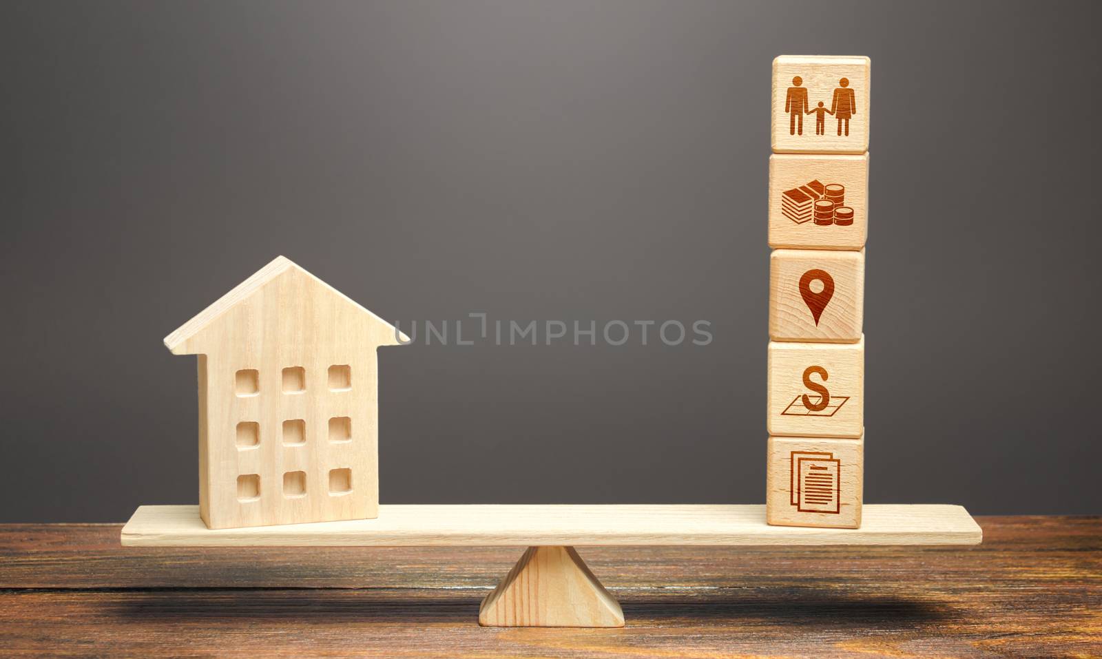 House and blocks of real estate parameters on scales. Searching for a suitable house by criteria. Realtor services. Price, area, location and infrastructure. The best home choice on the market.