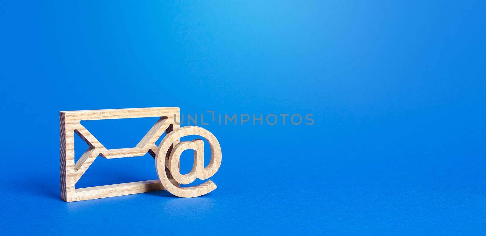 Email figure on blue background. Envelope and AT commercial sign symbol. Concept of email address. Contacts and communication. Business representations on the Internet and social media. Feedback