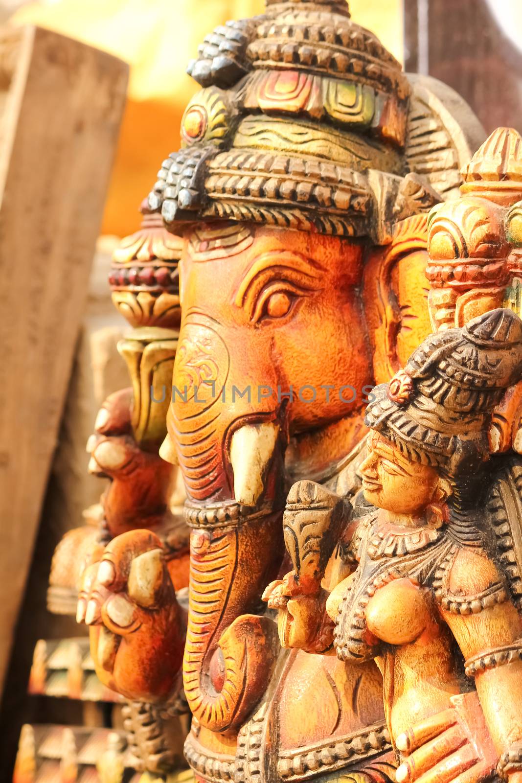 Side view of colored idol of God Ganesha with goddess Ridhi Siddhi