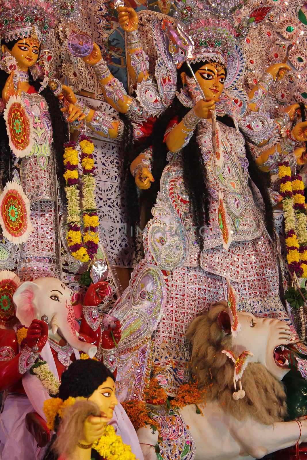 Statue of goddess durga along with Lord Ganesha and Saraswati, decorated during navratri pooja