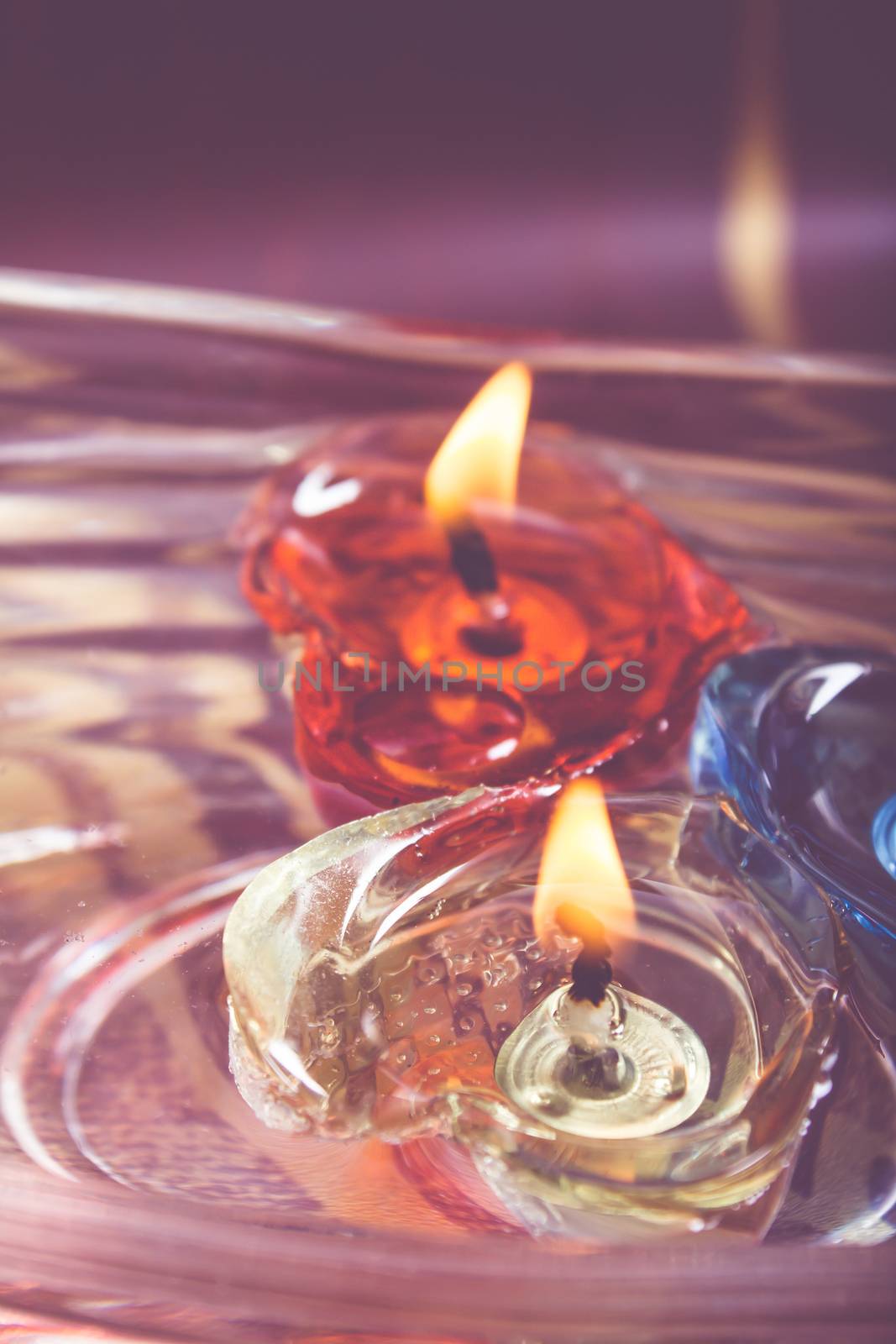 floating burning candles in glass aroma bowl - retro style
