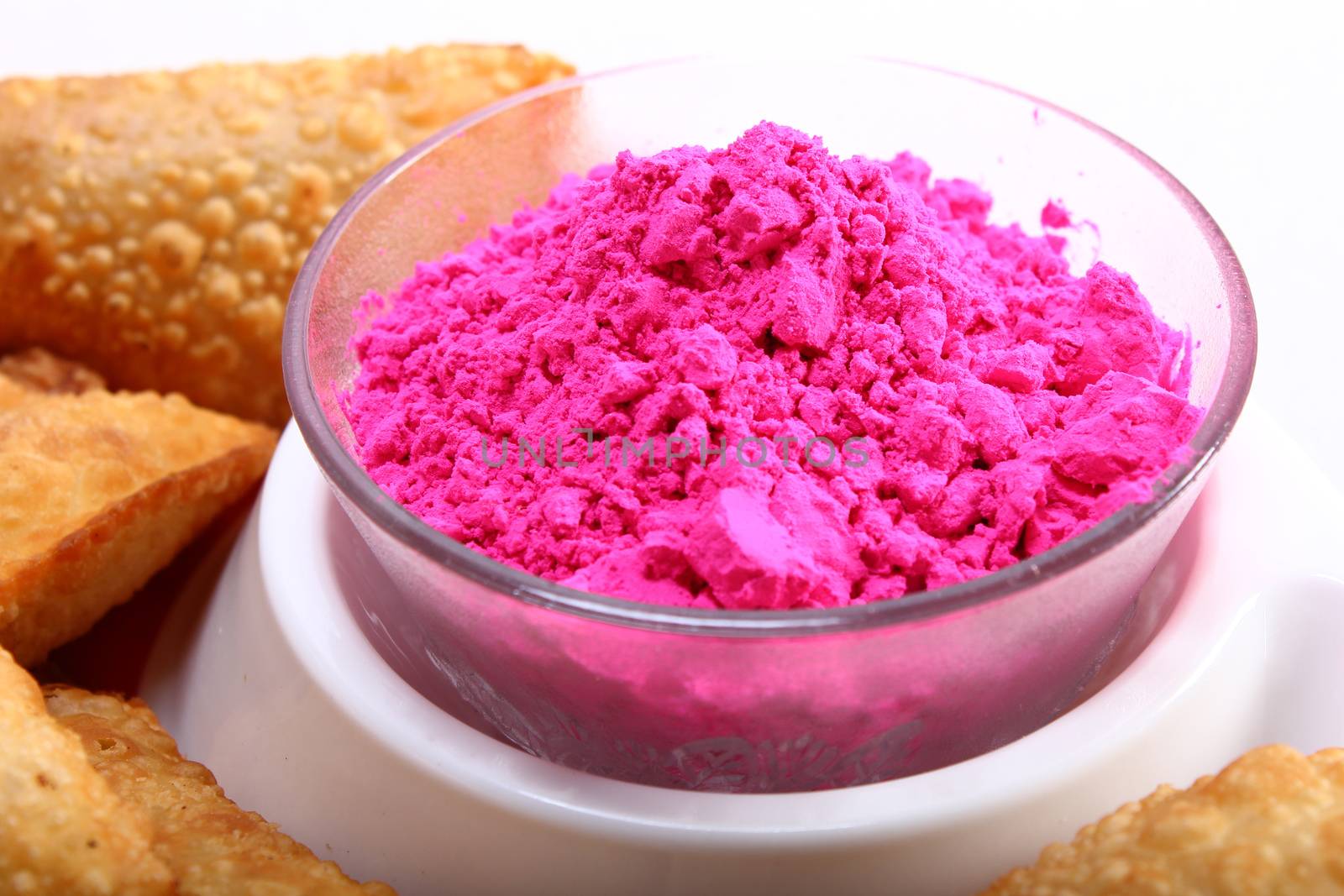 pink holi color in bowl with gujia