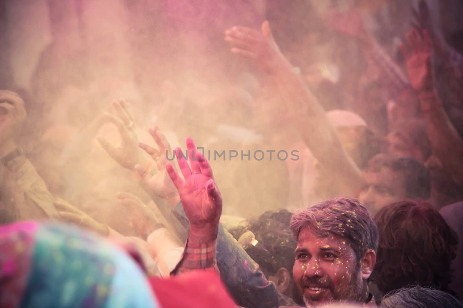 BARSANA - MAR 09: Devotees celebrate the traditional and a ritualistic Holi at Radharani temple on March 09, 2014 in Barsana, India. Holi is the most celebrated and colorful festival in India.