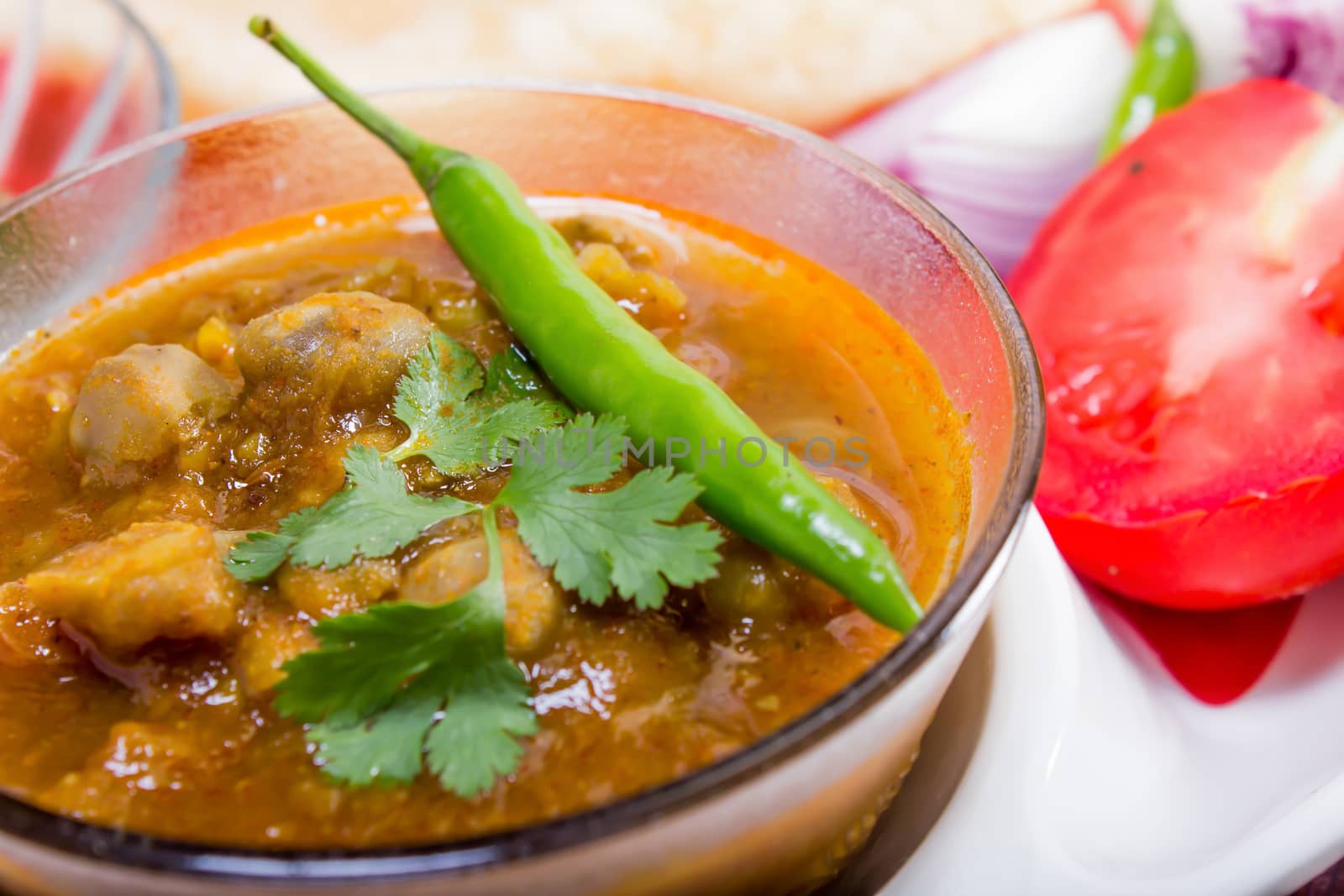 spicy chana masala, with green chilli topping, indian dish