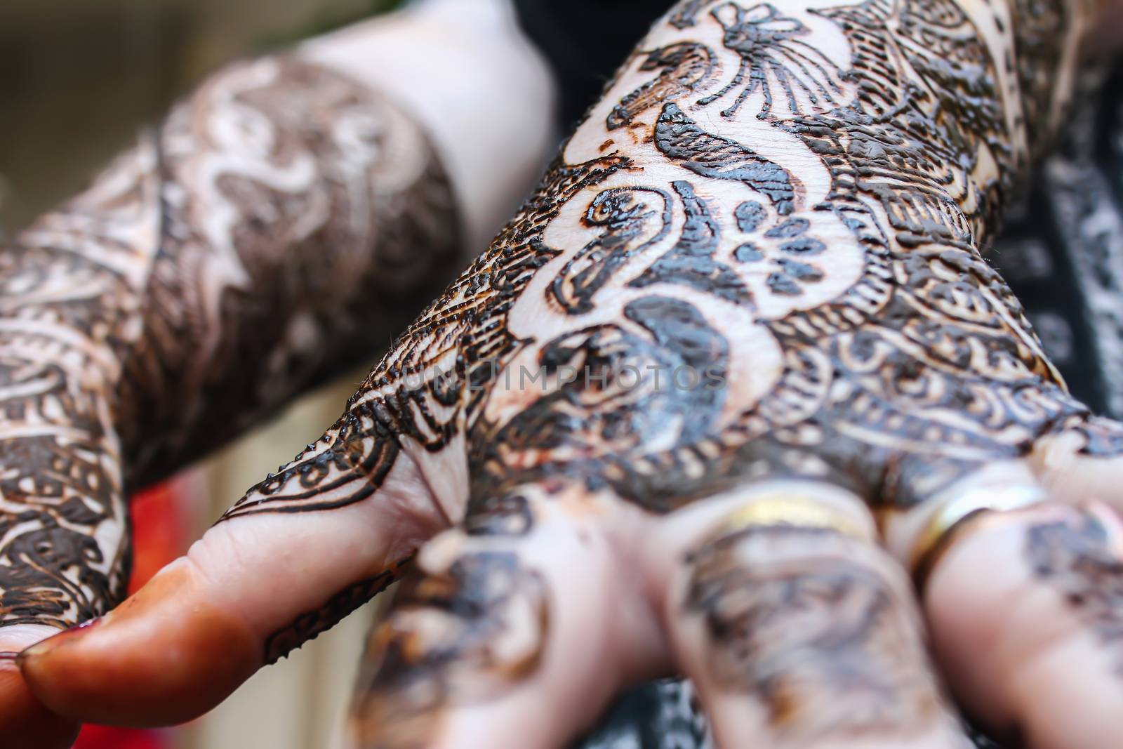 designing henna is applied to the hands of a hindu bride
