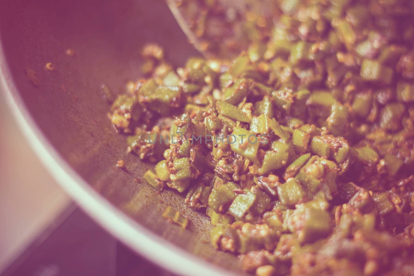 close up of home made masala bhindi or ladyfinger in aluminium karahi