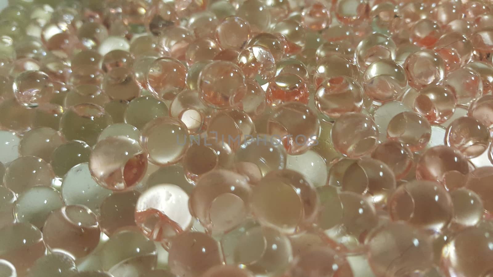 Closeup view with selective focus of shiny glittering orbeez or colorful water balls hydrogel. Water beads orbeez background.