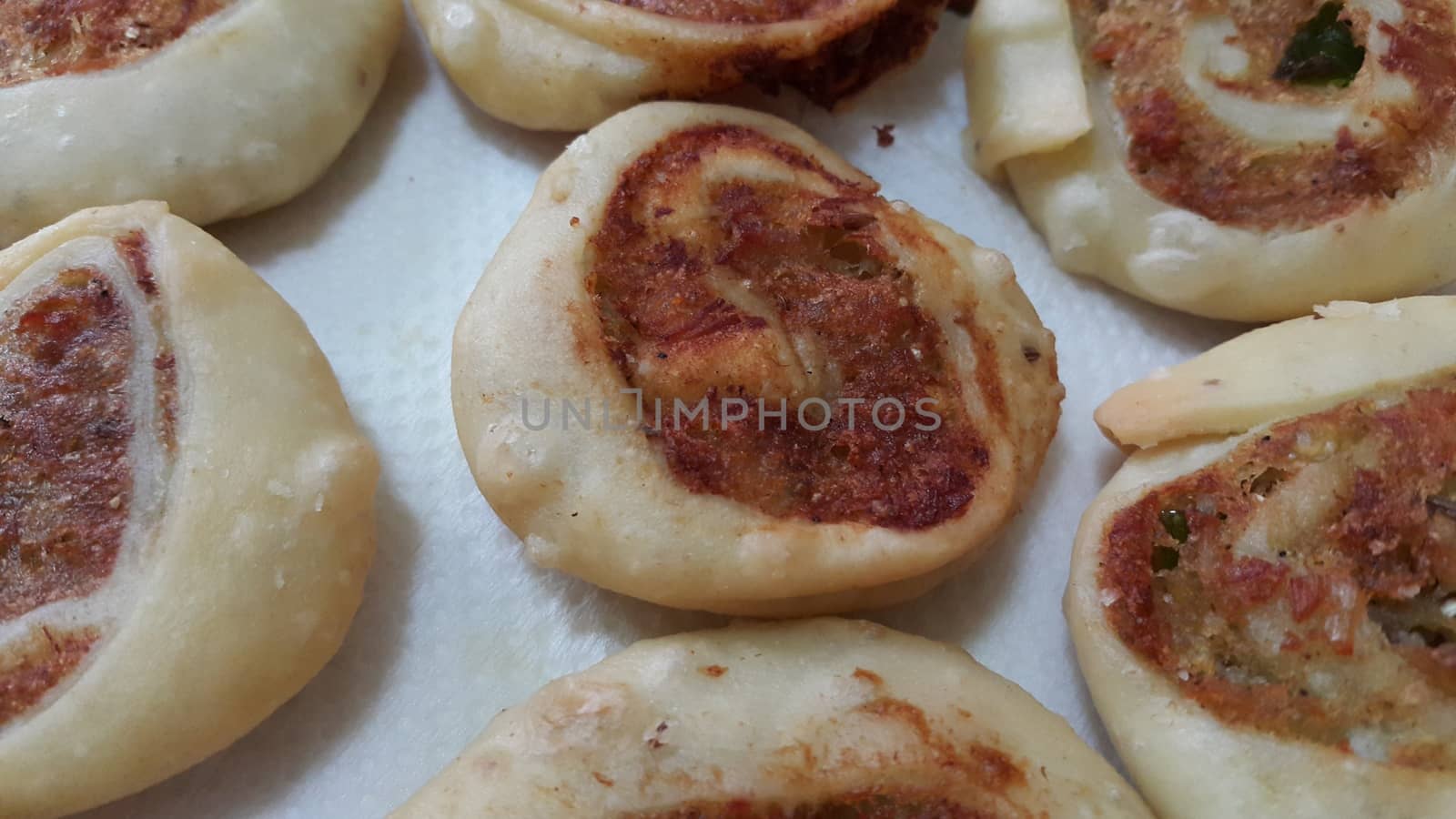 Closeup of delicious home made pinwheel puff pastries food item placed over white background