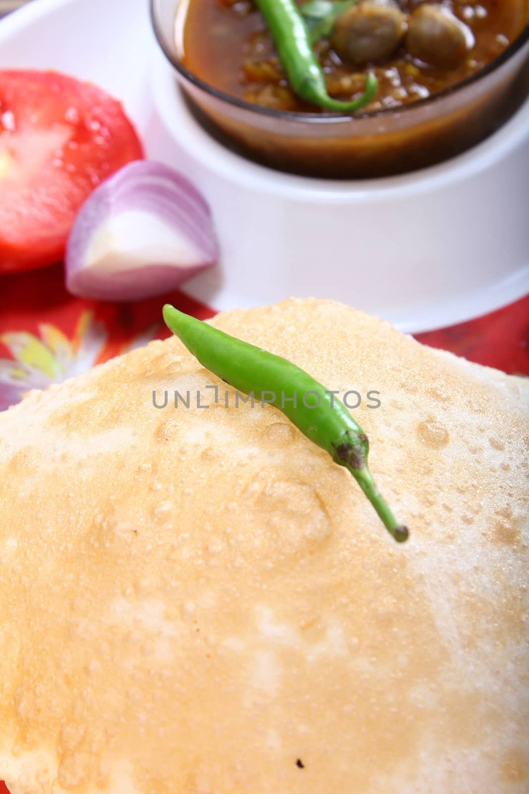 indian spicy dish, chole bhature topping of green chili by frameshade