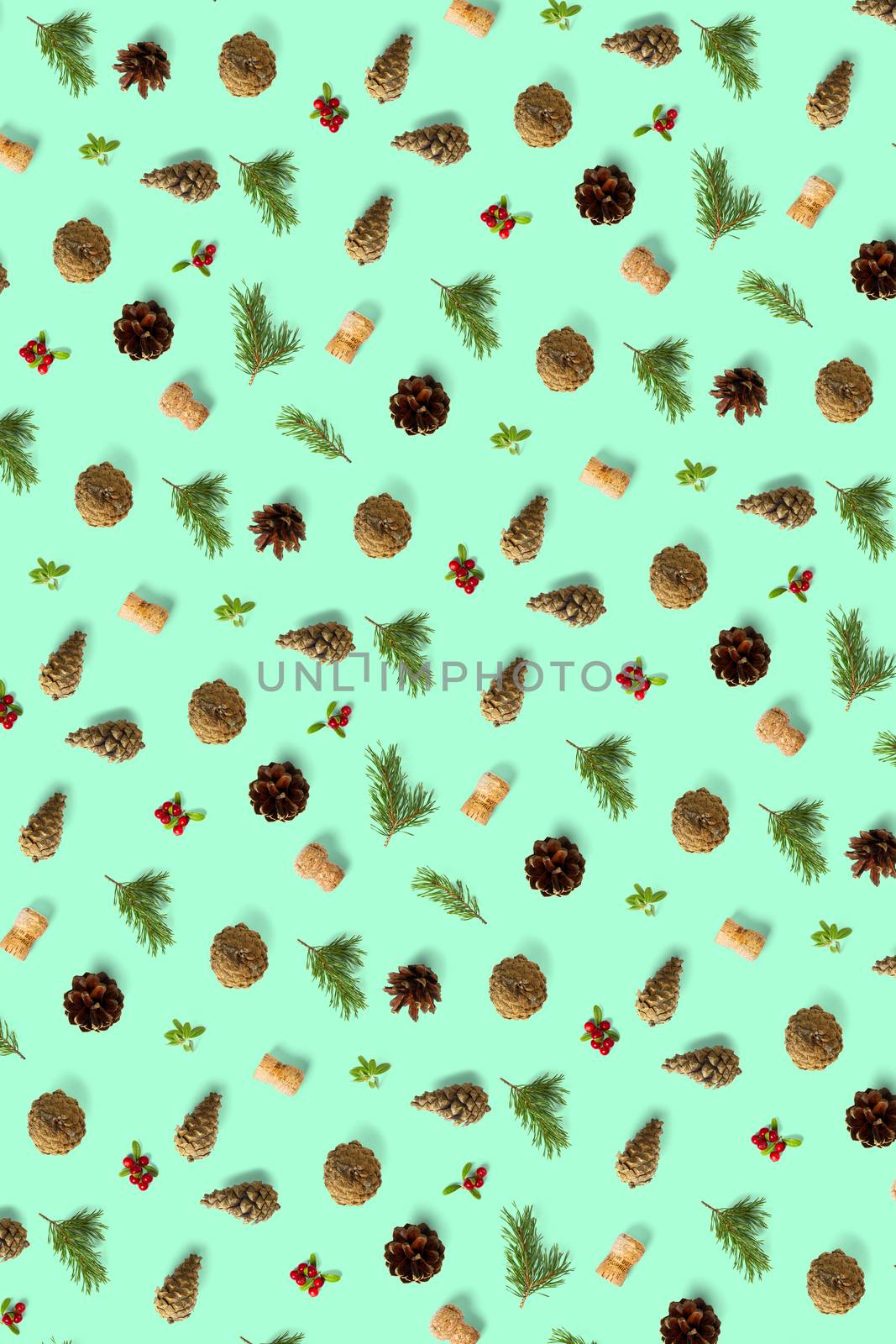 christmas background with pine cone, wine cork, pine twig and lingonberry. christmas background on green backdrop