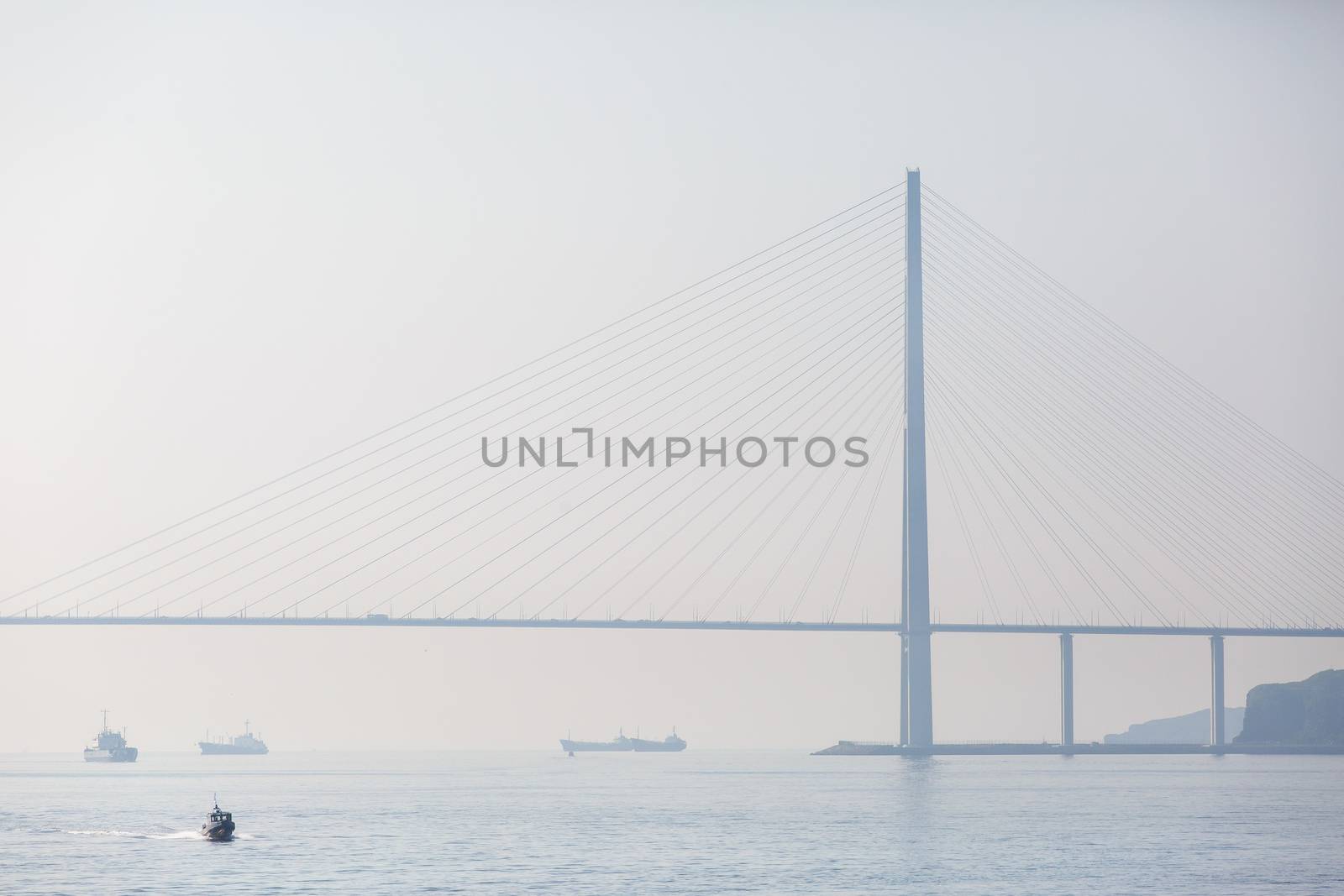 Russian bridge in Vladivostok is shrouded in thick fog.