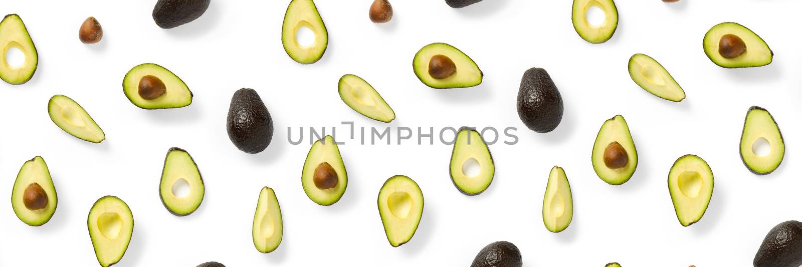 Avocado banner. Background made from isolated Avocado pieces on white background. Flat lay of fresh ripe avocados and avacado pieces. by PhotoTime