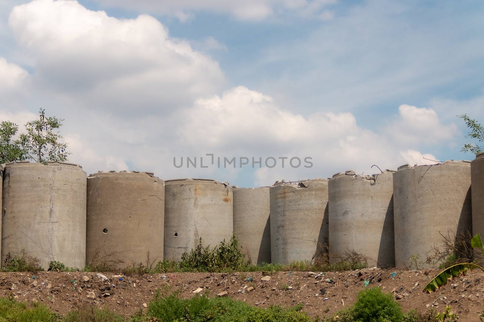 concrete pipe wall on a sunny day. fence by leo_de_la_garza