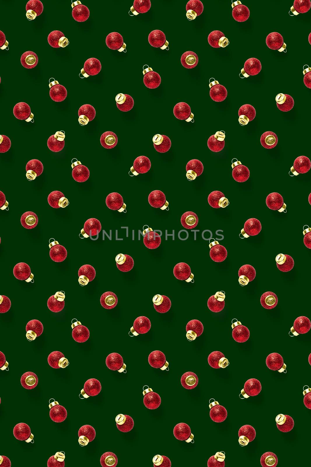 Christmas red decorations on green background. Christmas ornaments composition for background. Flat lay background madefrome red ornaments decorations