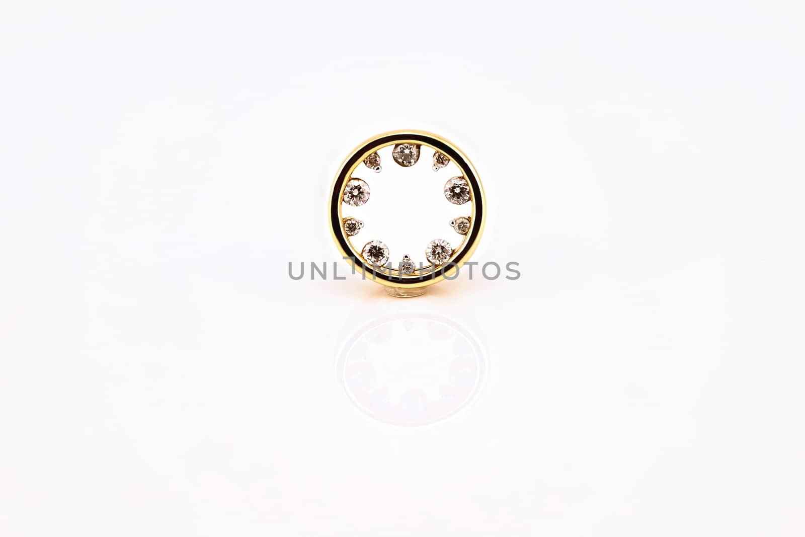 A circle of diamonds pendant set in yellow gold, isolated on a white background