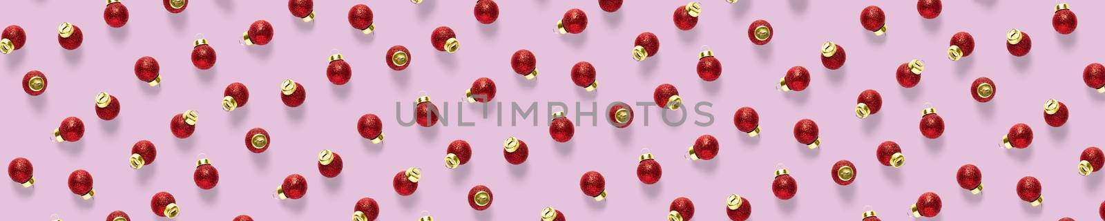Christmas red decorations on pink background. Christmas ornaments composition for background. Flat lay of red ornaments by PhotoTime