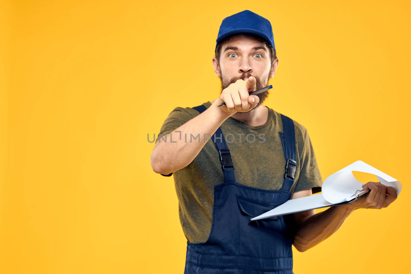 Man in working form documents transportation delivery service yellow background. High quality photo