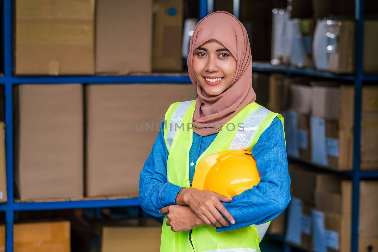 Portrait of Muslim worker woman wearing Hijab and standing and h by Tzido