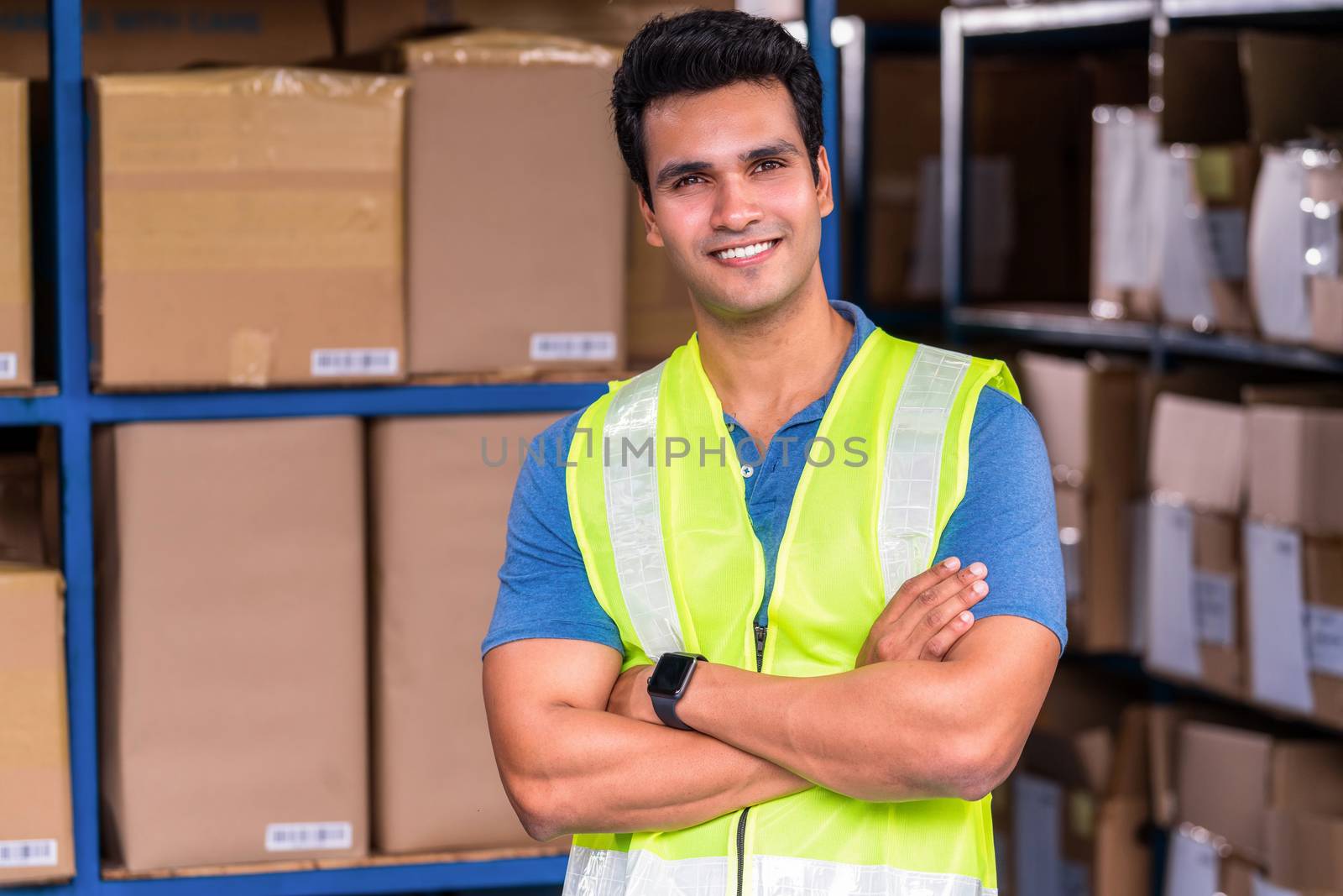 Portrait of Idian worker man standing in arm crossed action in local warehouse before start his job, business and industry, business reopening after Covid19 outbreak,