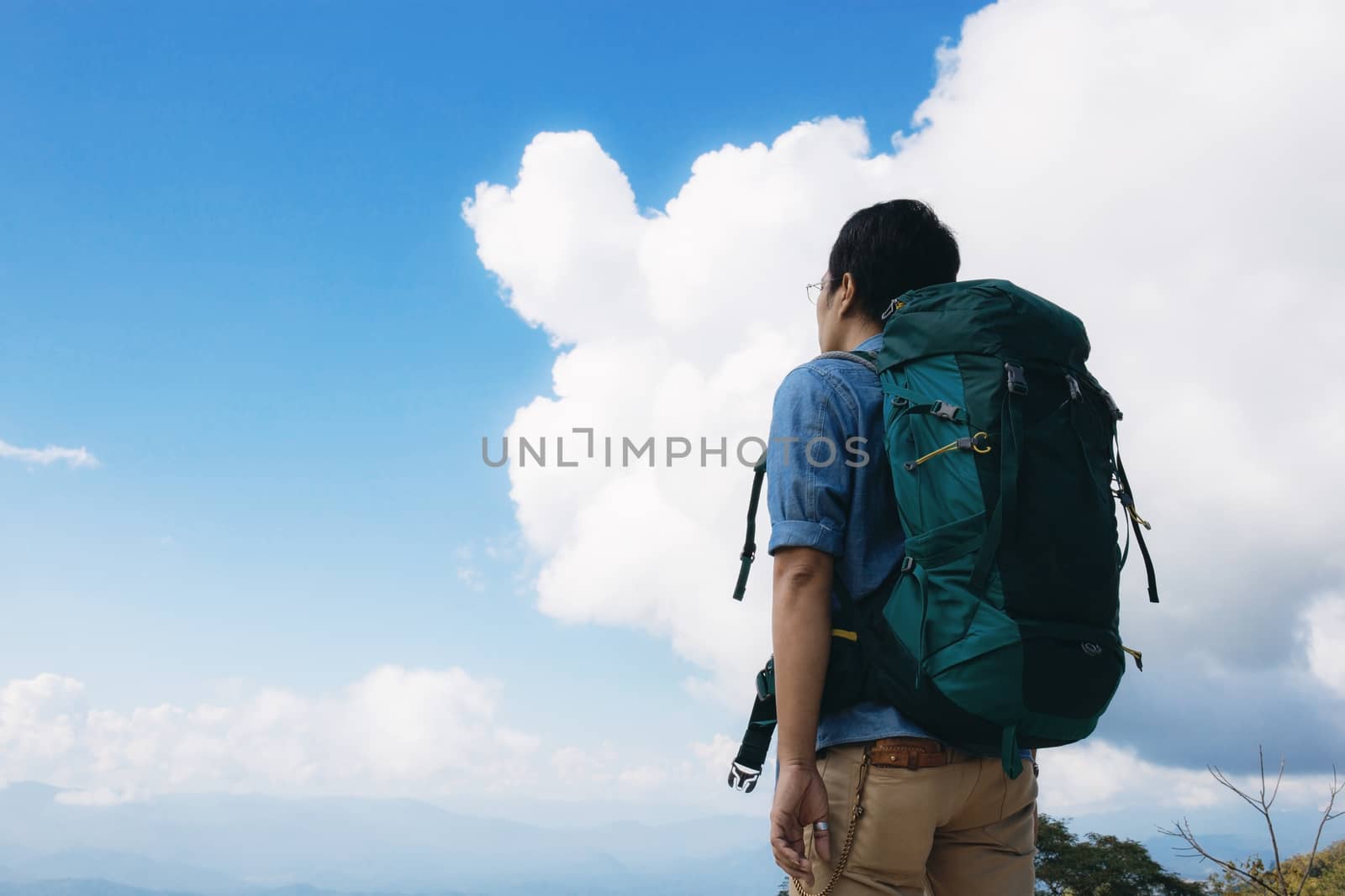 Man of traveler on mountain with the blue sky.