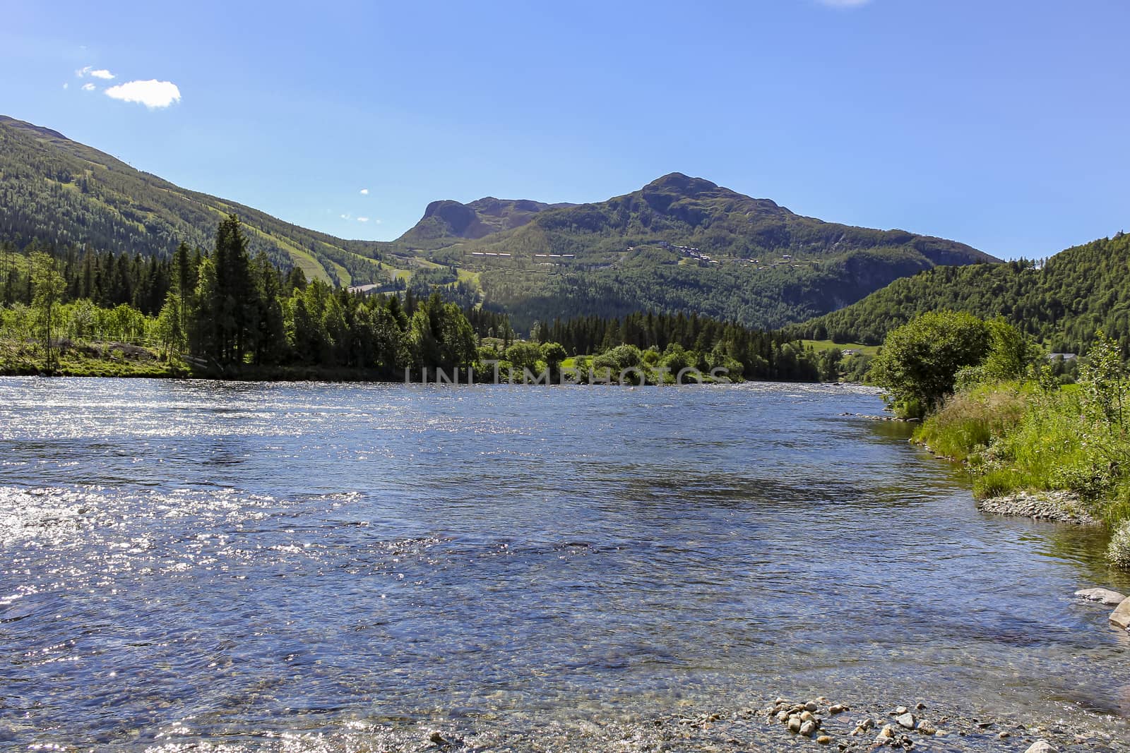 Flowing beautiful river lake Hemsila with mountain panorama in Hemsedal, Viken, Buskerud, Norway.