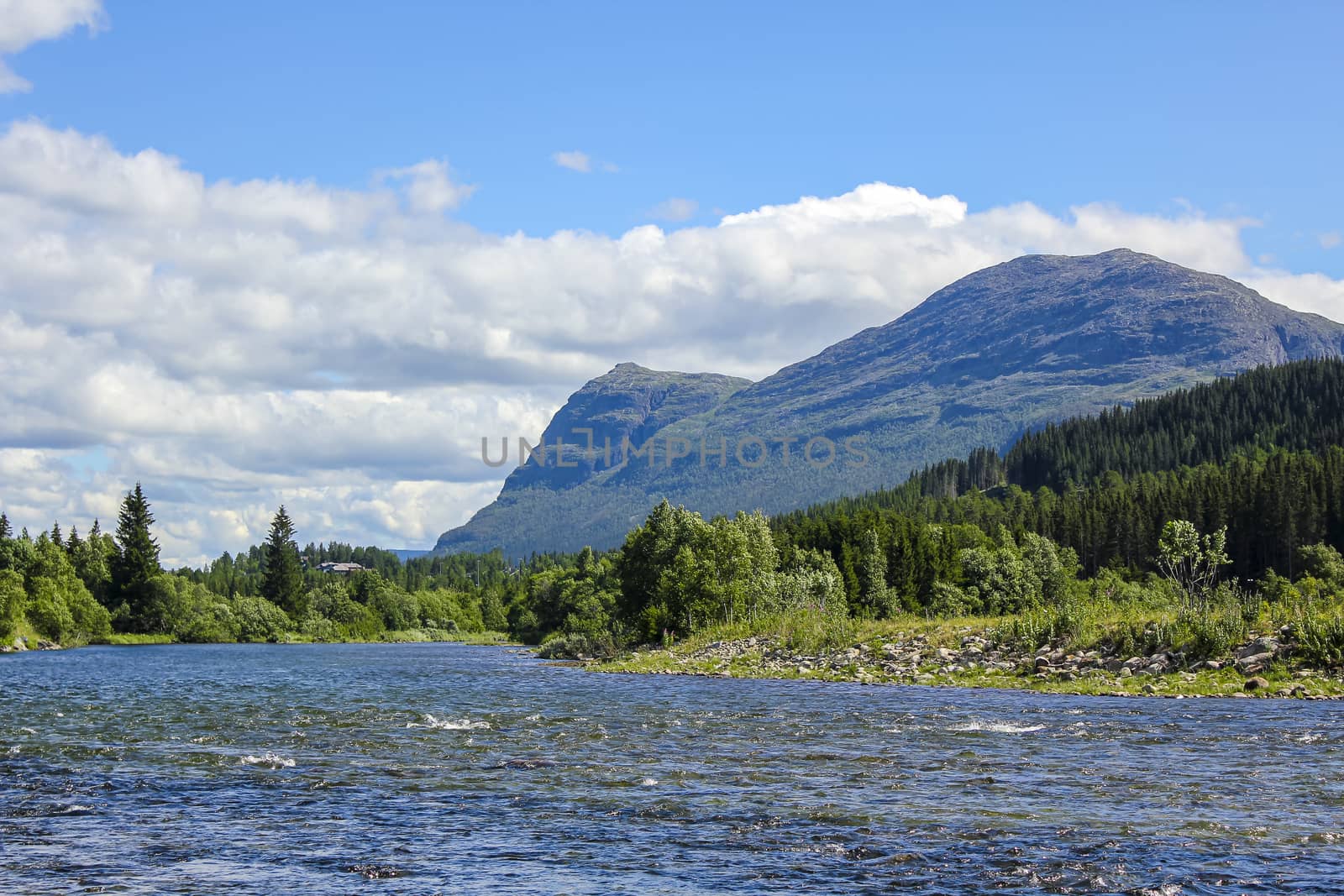 Flowing beautiful river lake Hemsila with mountain panorama in Hemsedal, Viken, Buskerud, Norway.