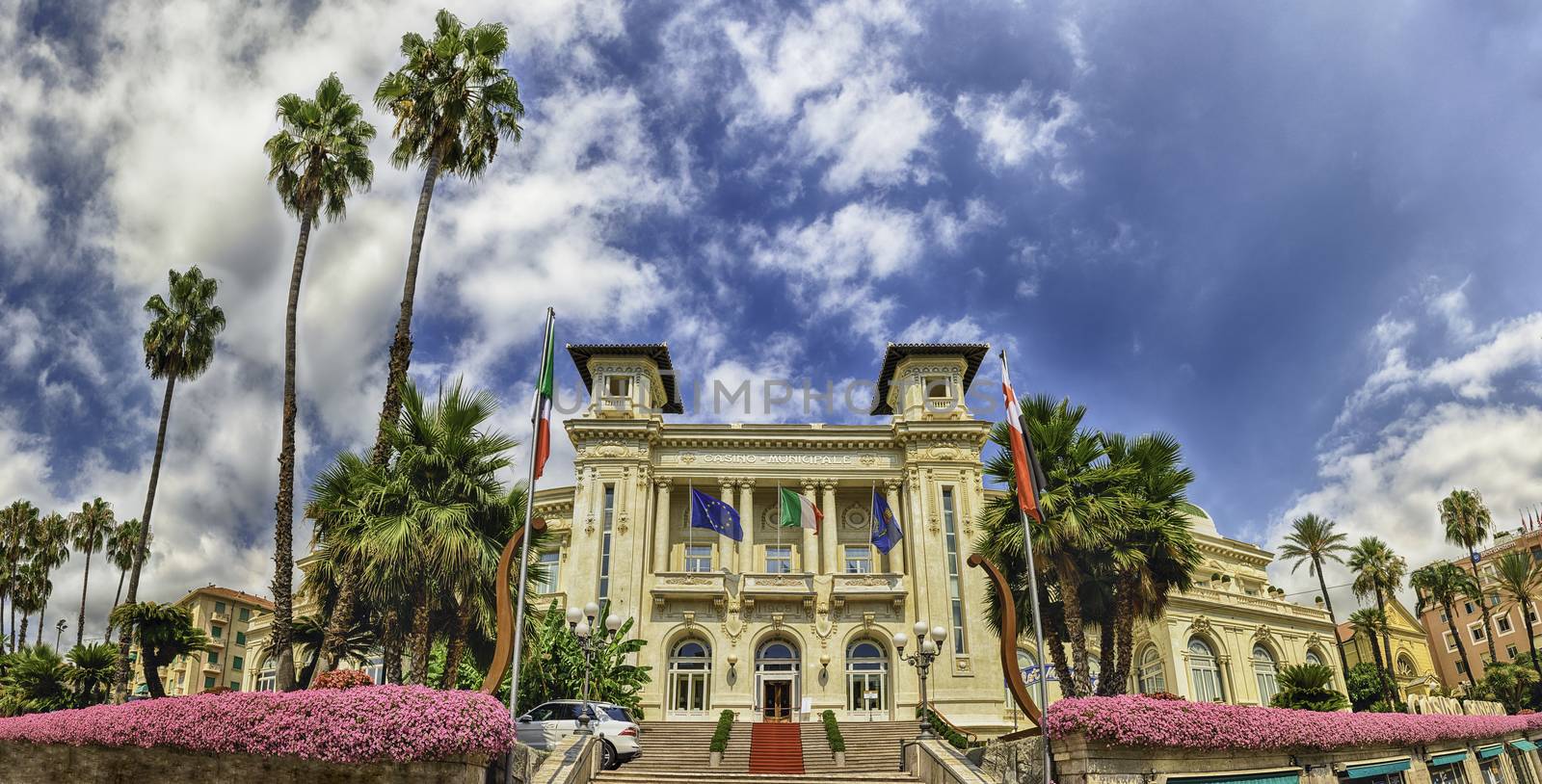 Facade of the scenic Sanremo Casino with palms and flowers by marcorubino