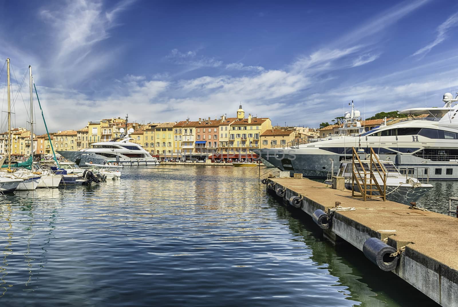 View of the old harbor with luxury yachts of Saint-Tropez, Cote d'Azur, France. The town is a worldwide famous resort for the European and American jet set and tourists