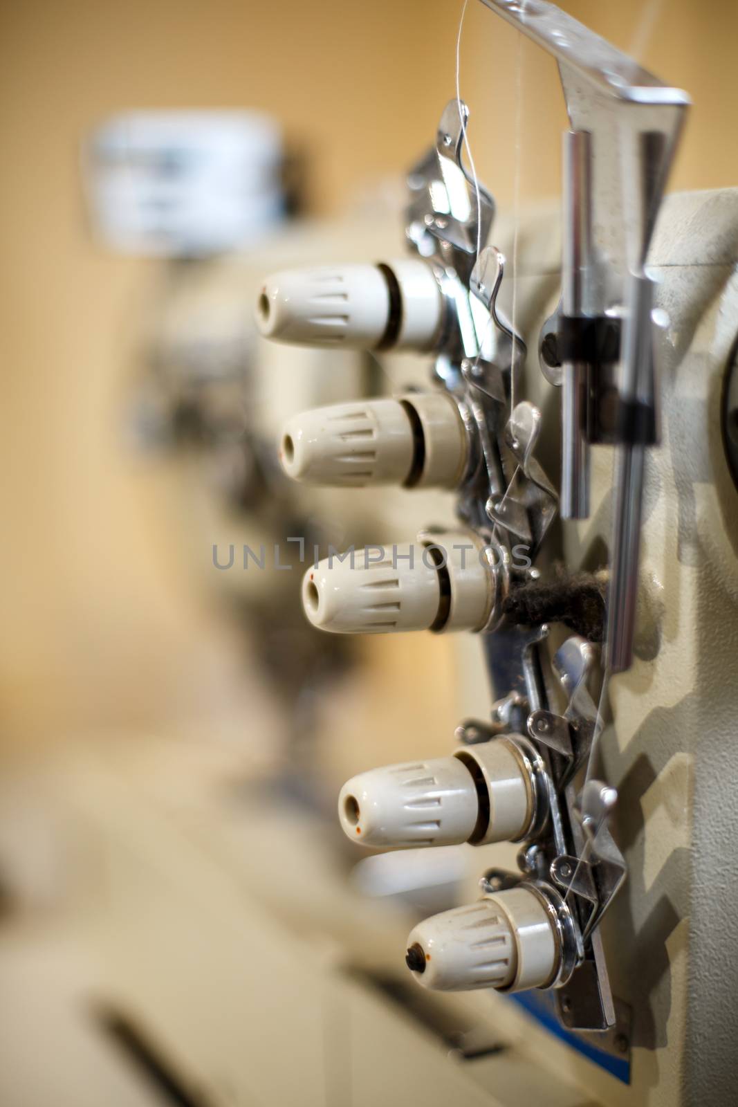 closeup details on sewing machine overlock. Workplace seamstress.Tailoring industry.