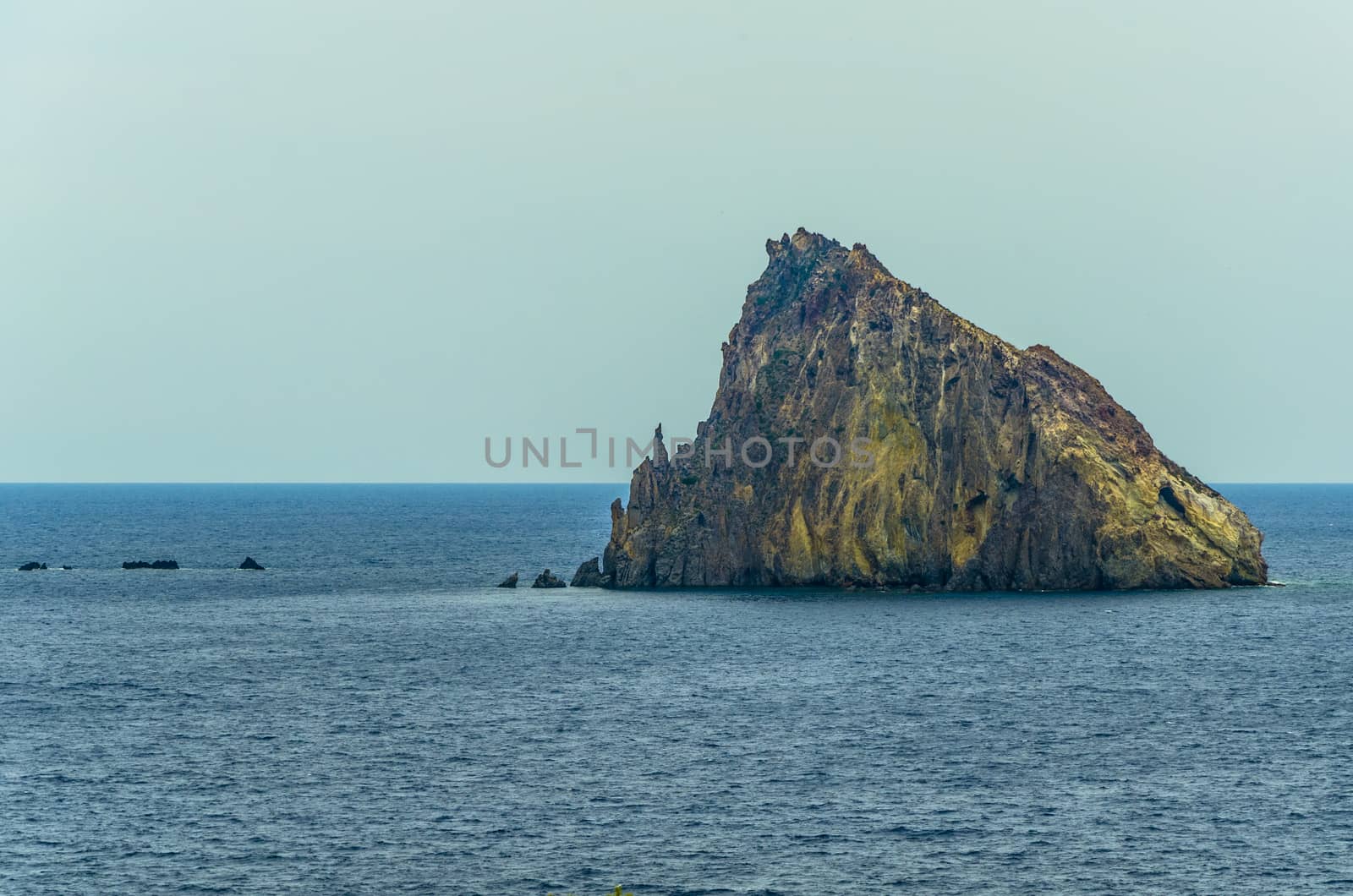 Isolated volcanic rock in the tyrrhenian sea in front of the coast of panarea island