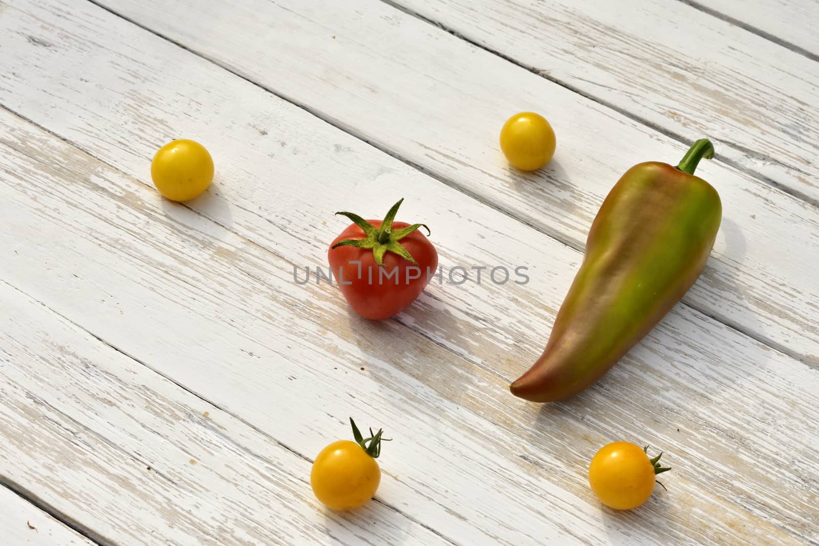 red tomato four yellow small tomatoes bell pepper pod