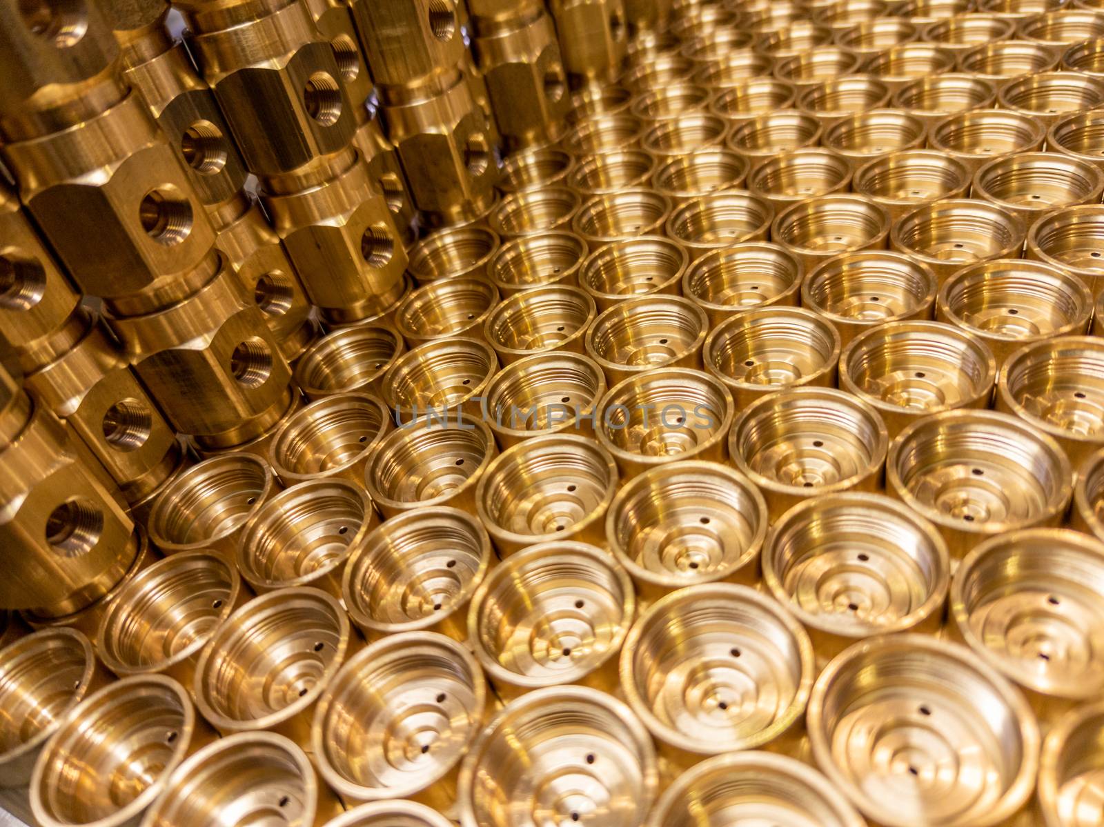 shiny brass metal threaded hexagonal fitting parts, abstract perspective industrial close-up background.