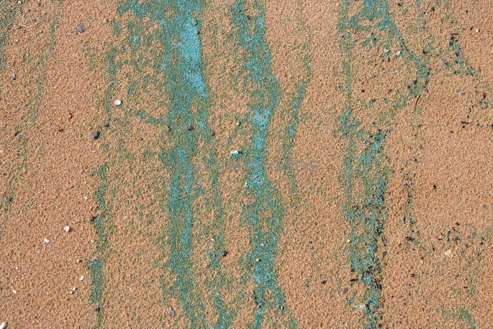 Sandy texture.Background of wet river sand with turquoise stripes of foam.The concept of the environment by lapushka62