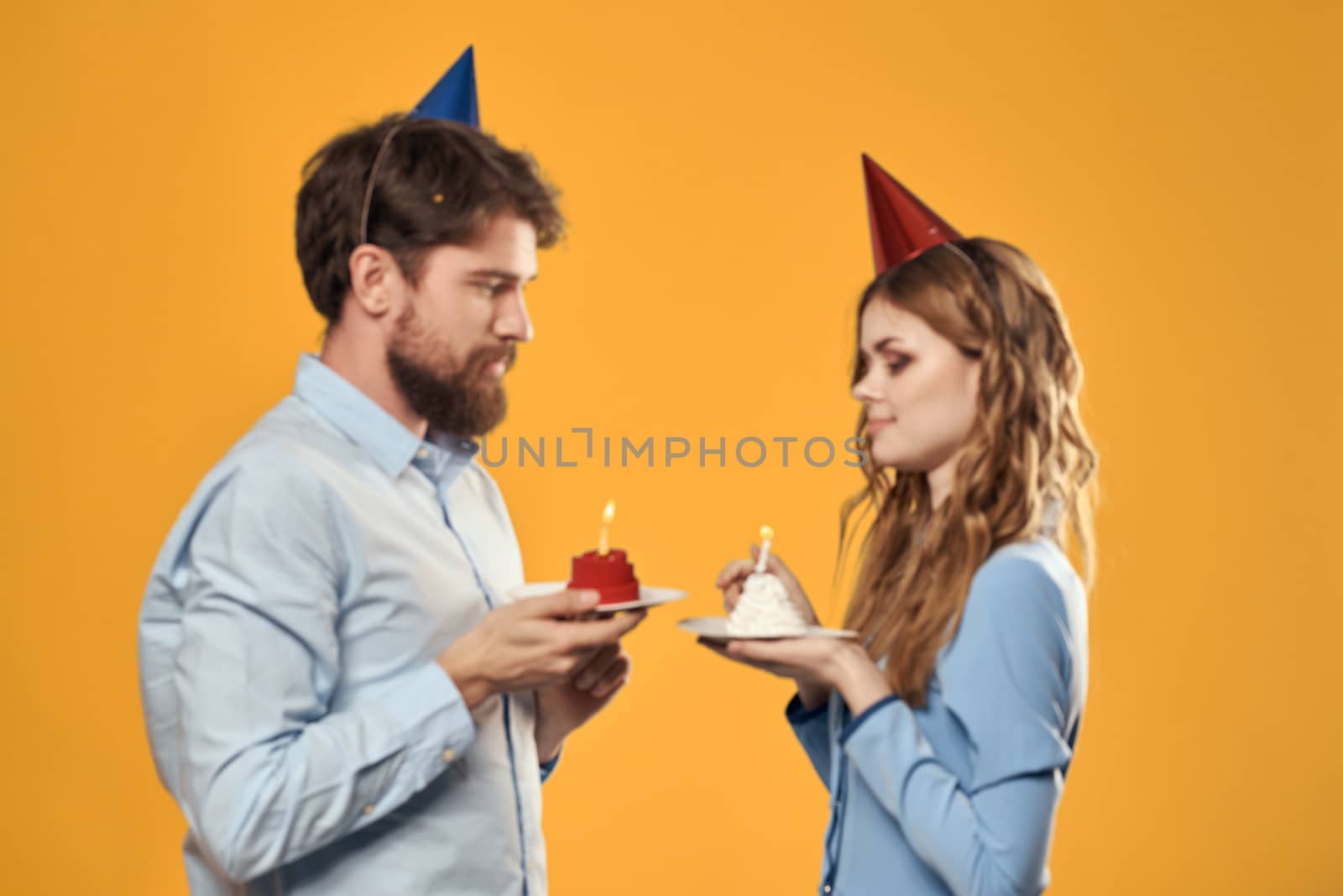 Man and woman fun and celebration Birthday joy vacation yellow background. High quality photo