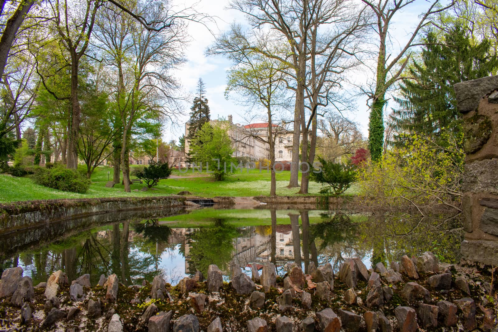 Looking Out Over a Lake at a Large Detailed Estate Reflecting Off the Water's Surface