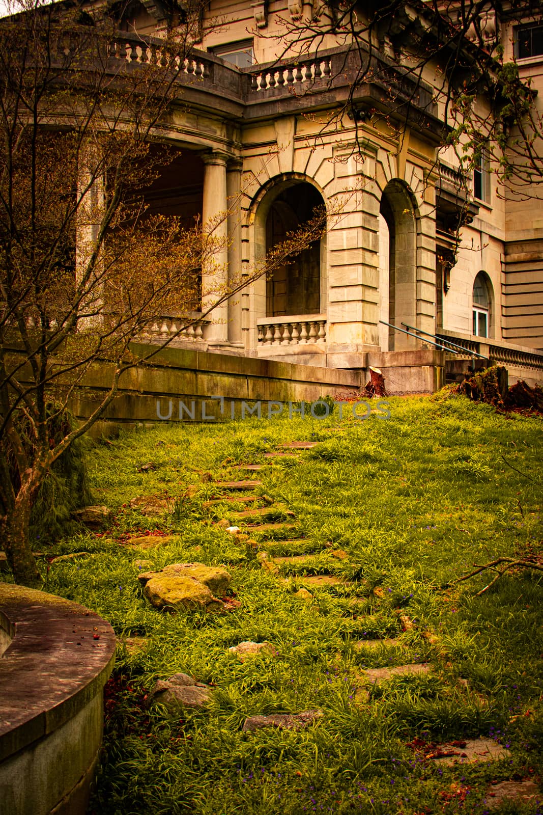 Stepping Stones Leading Up to an Arched Entrance to an Ornamental Stone Mansion