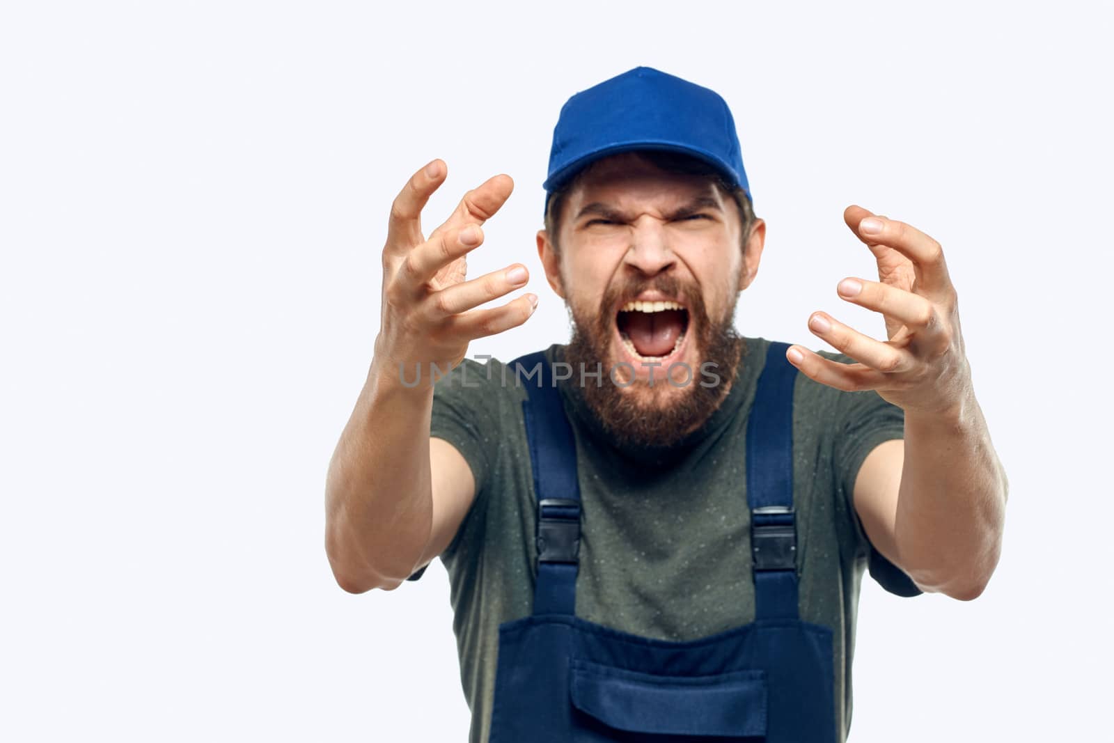 Worker man uniform delivery service emotions studio light background. High quality photo