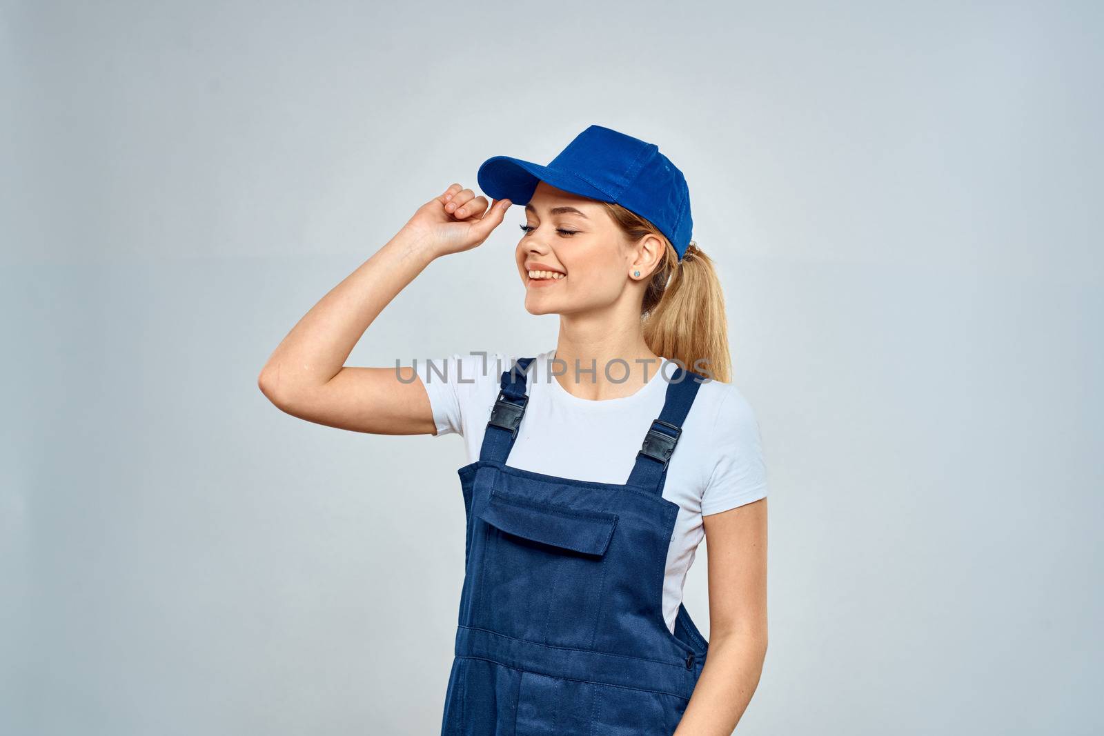 Woman in working uniform blue cap service lifestyle service by SHOTPRIME