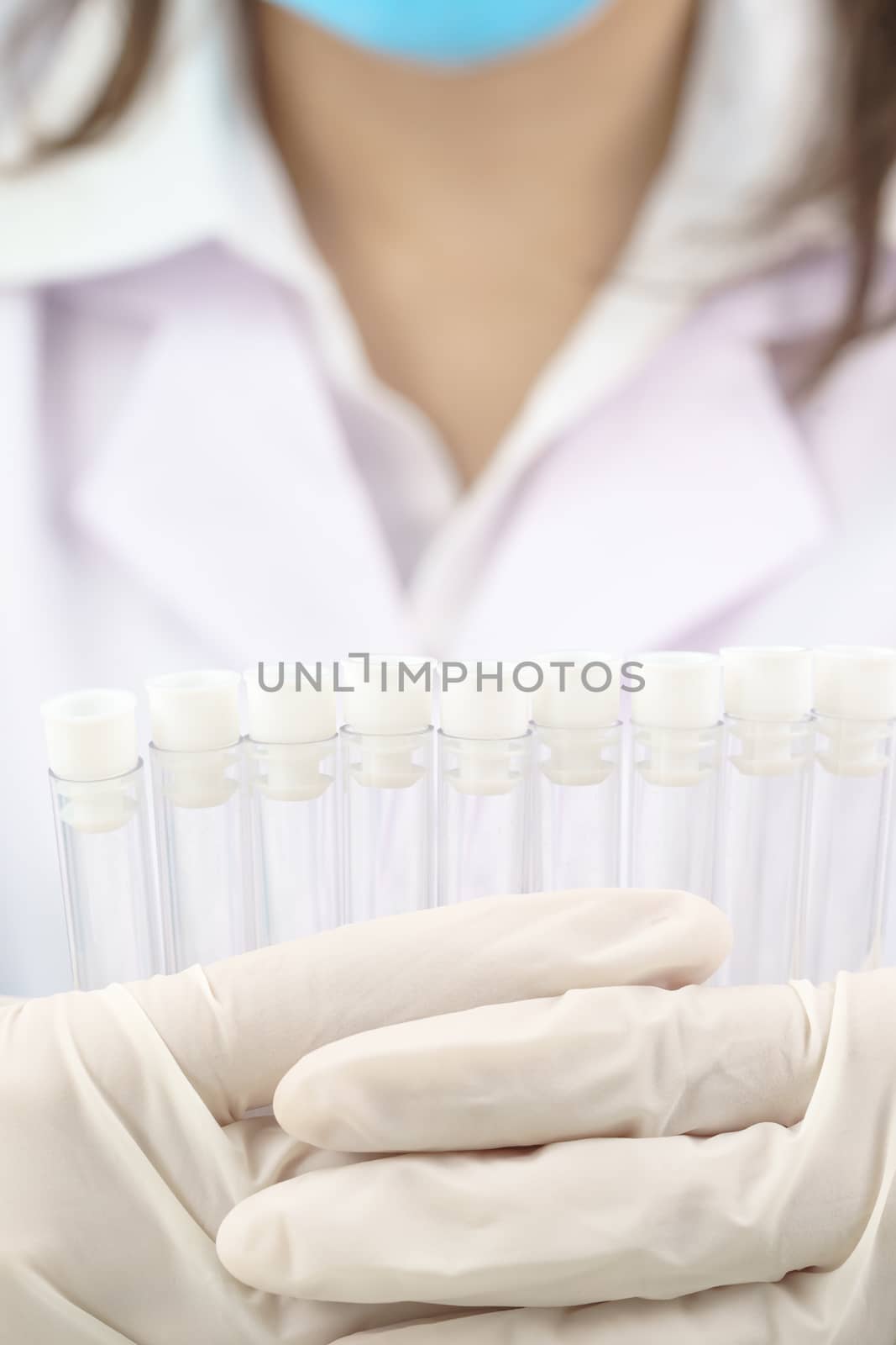 Scientist analyzing holding test tube in laboratory by stoonn