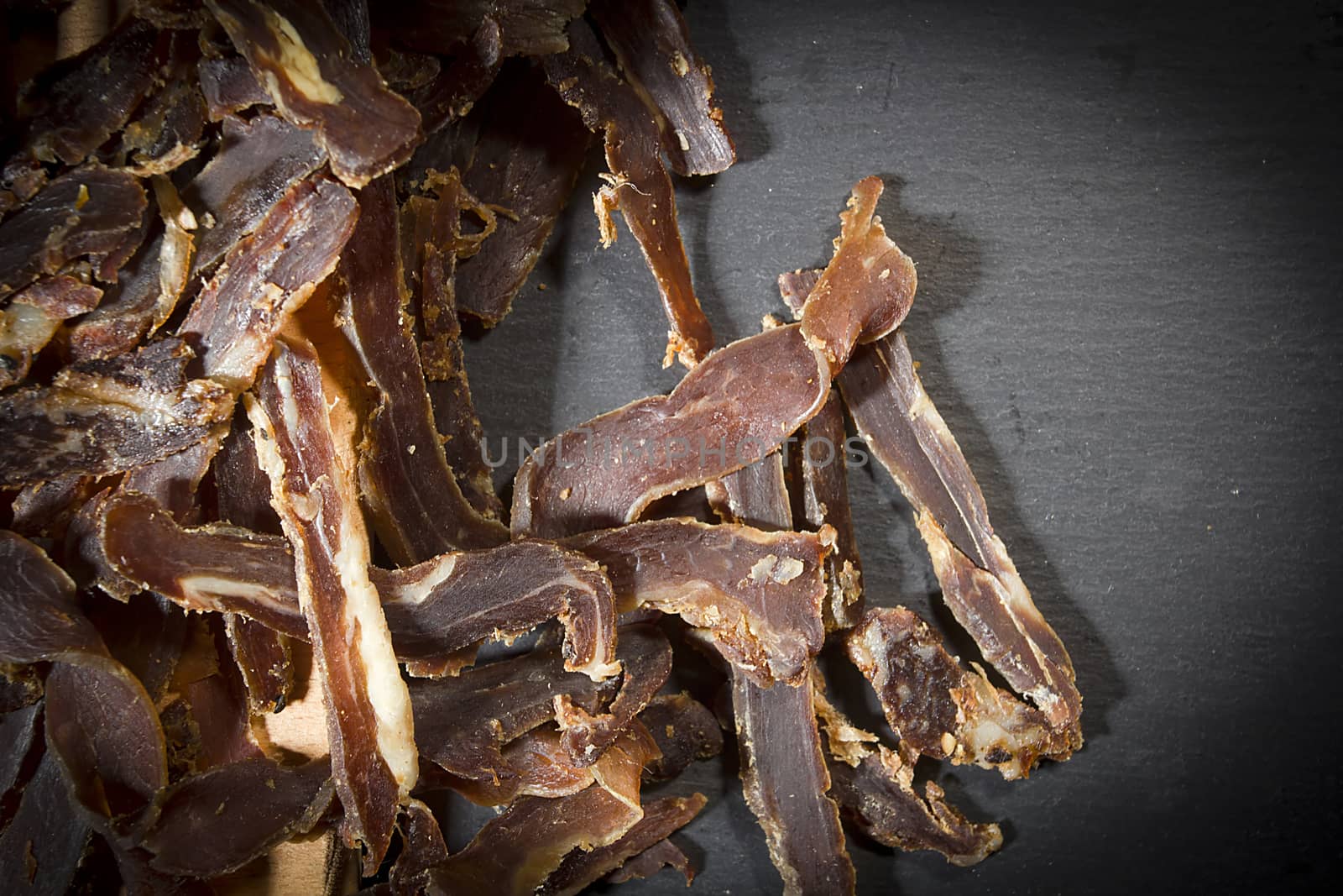 Beef jerky sliced on a stone cutting board