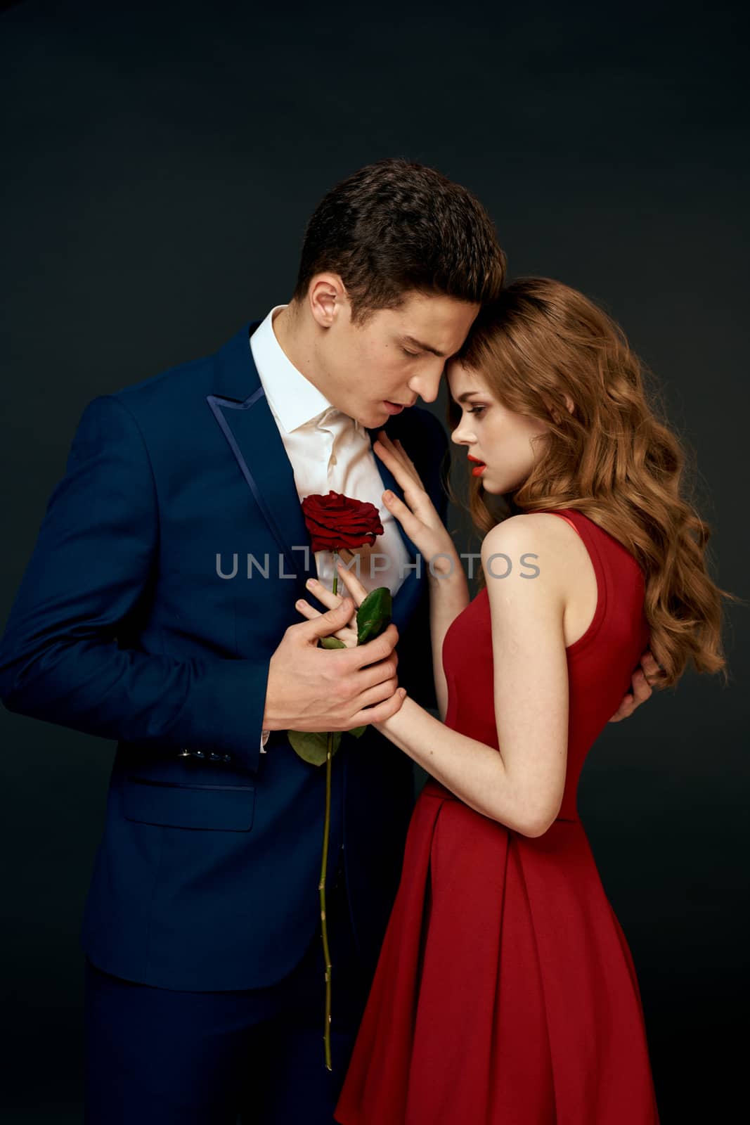 Beautiful couple charm hug lifestyle relationship rose luxury dark background. High quality photo