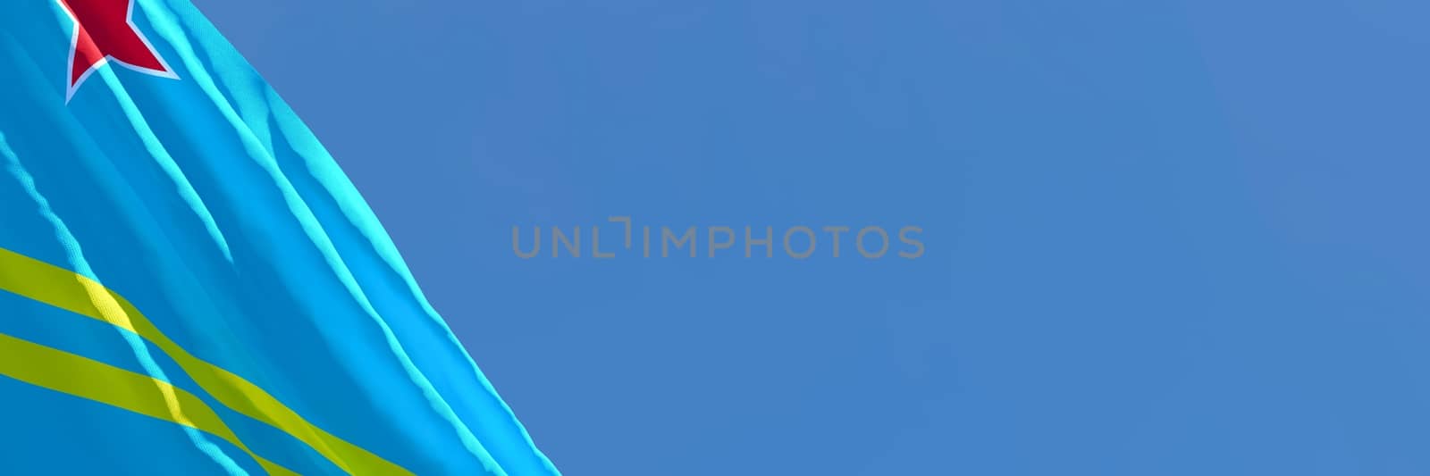 3D rendering of the national flag of Aruba waving in the wind against a blue sky