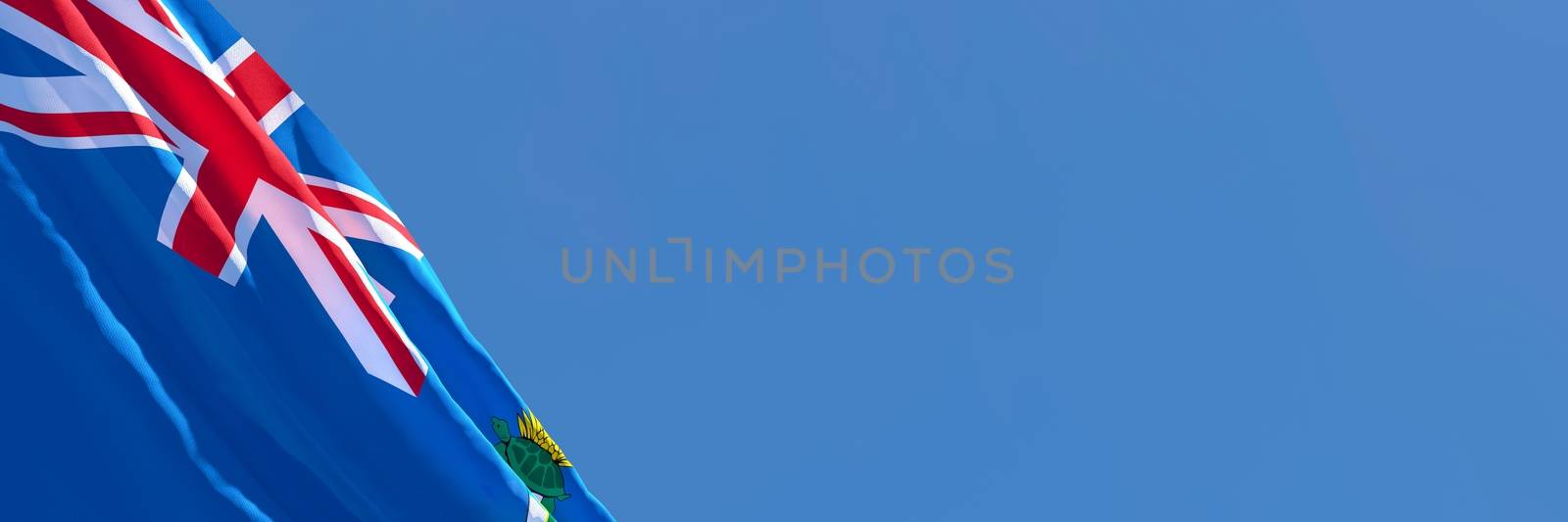 3D rendering of the national flag of Cayman Islands in the wind against a blue sky