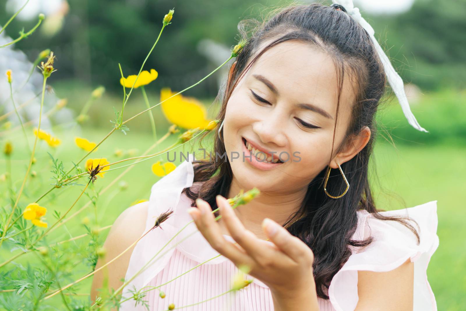 Portrait of asian happy woman smilling with flower garden , Selective focus