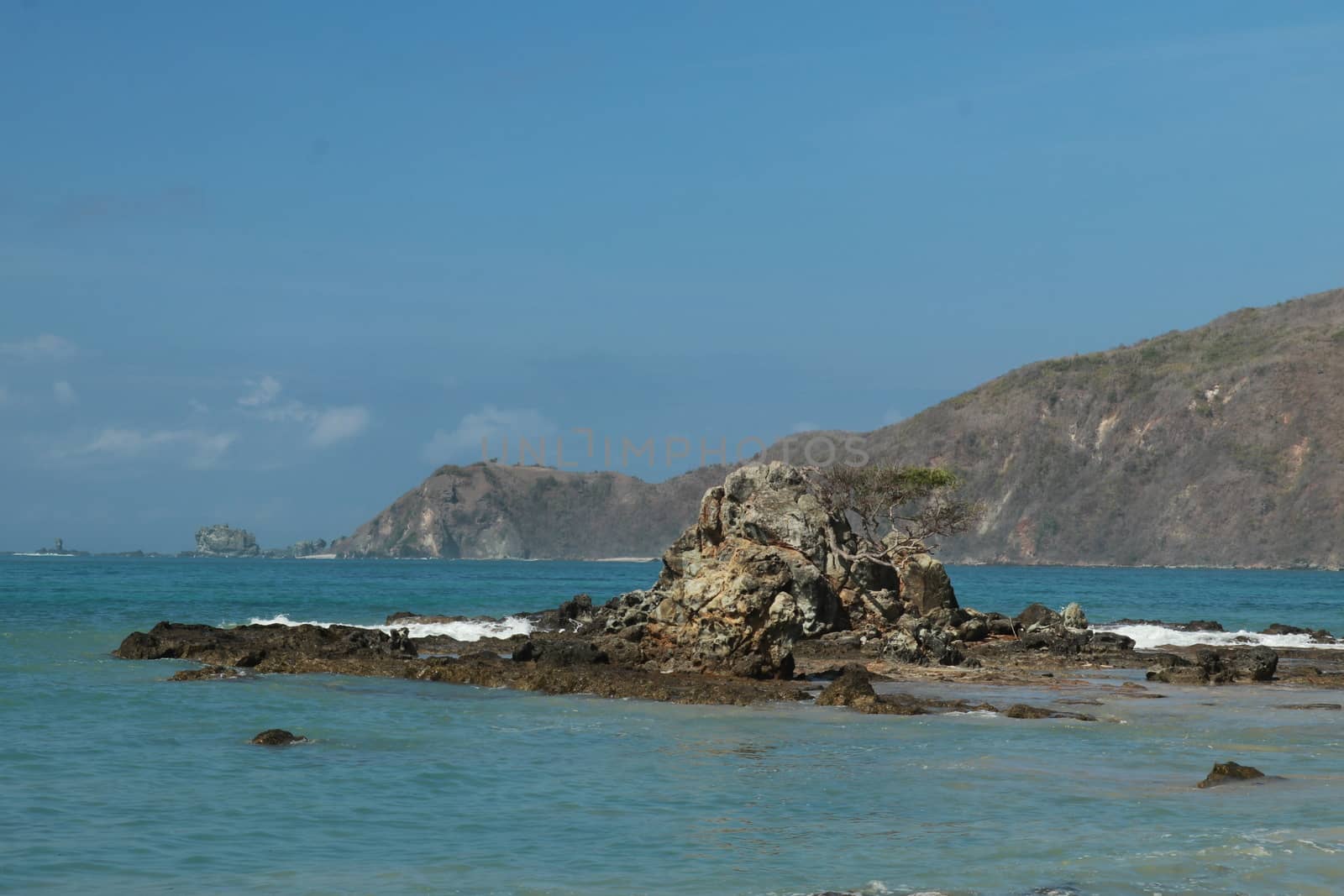 Rock formations on the beach Mandalika Kuta beach, Lombok, Indonesia. Blue sky and suuny day.