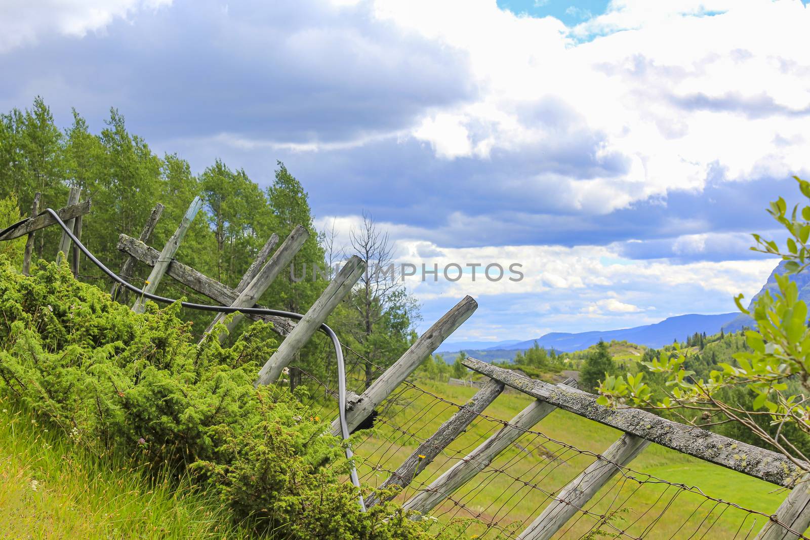 Stunning Norwegian landscape with mountains and valley behind a broken fence in Hemsedal, Norway.