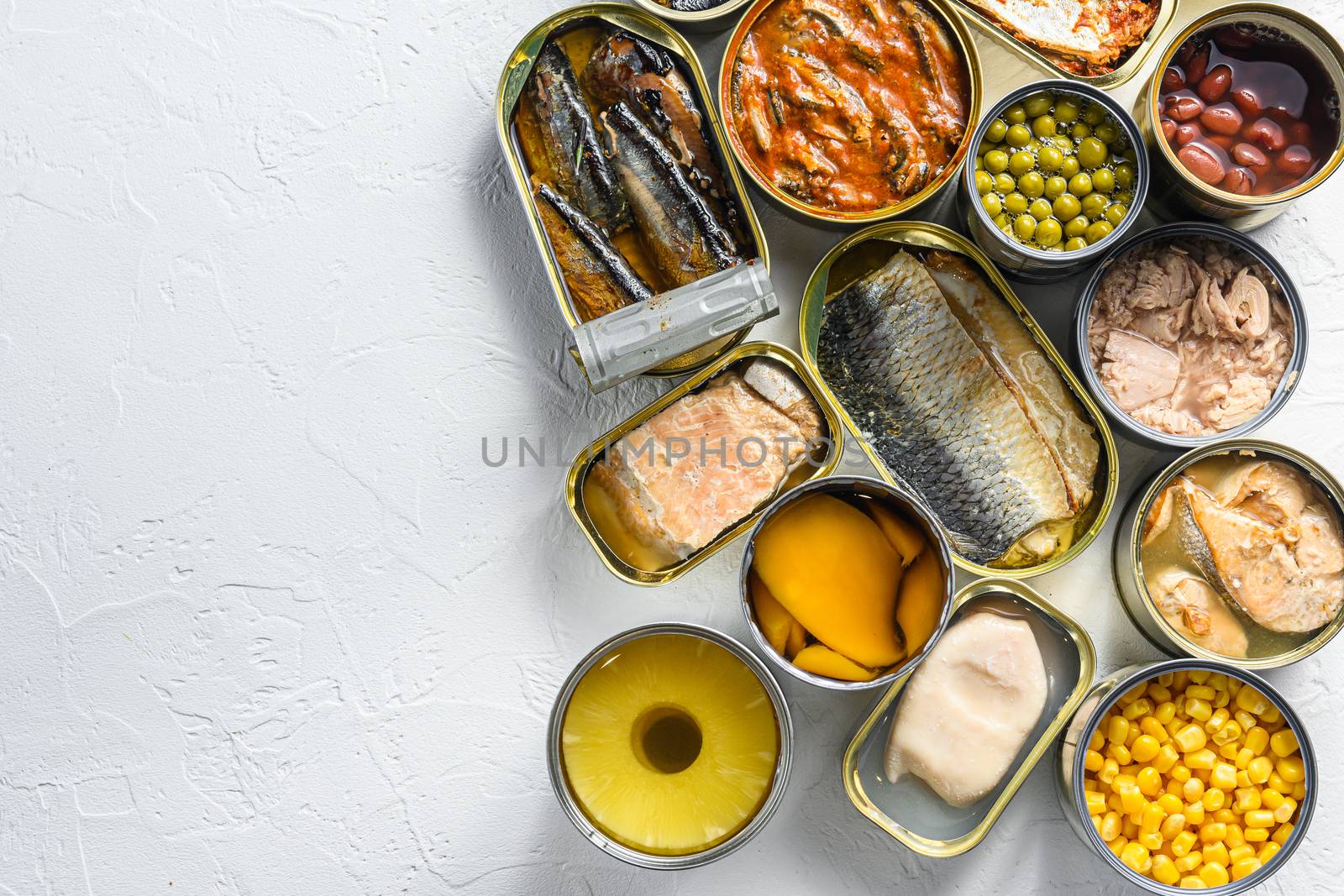 Tin cans for processed food cans conserve Saury, mackerel, sprats, sardines, pilchard, squid, tuna pinapple, corn, peas, mango , beans, over white textured background top view space for text.