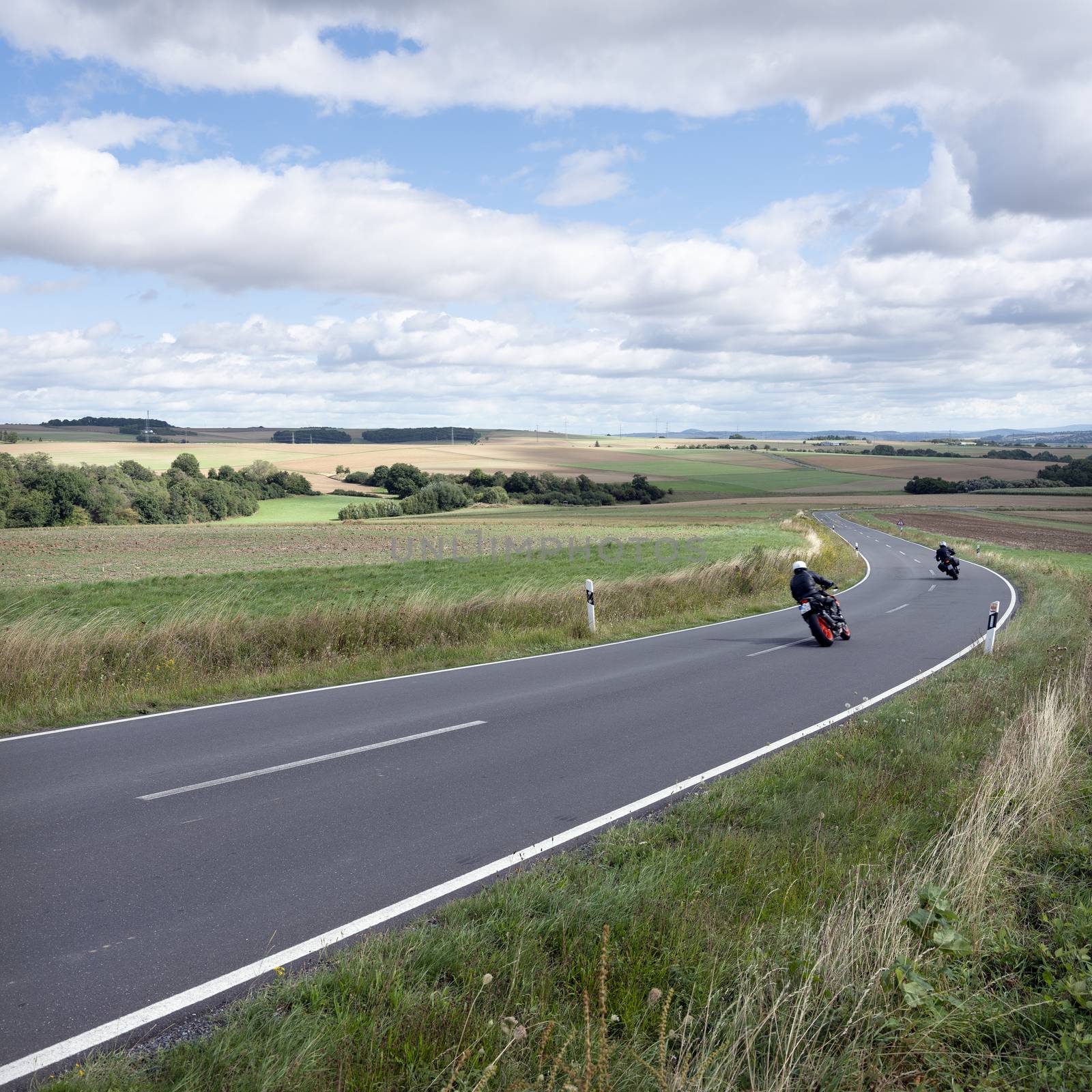 motorcycles on country road in rural landscape of german eifel