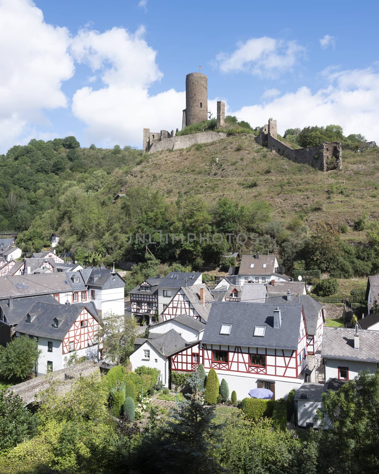 half timbered houses and castle ruin in beautiful village of Monreal in german eifel unbder blue sky